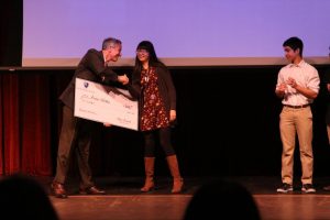 Head of School Dan Frank presents the $200 first place prize to Amanda Wang.