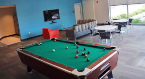 Amenities at Faison include a lounge area with a pool table. 